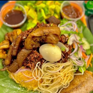 waakye with assorted meat stew and shito (chilling sauce) and fried red fish