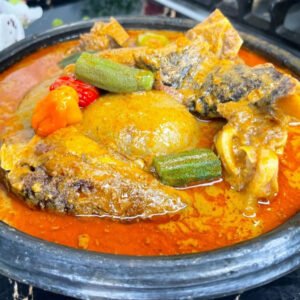 fufu with Abenkwan (palm nut soup)assorted meat and fish.