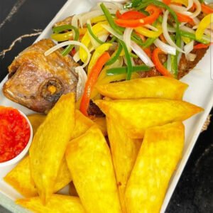 Fried yam with snapper red fish ,red sauce pepper, shito, with garnish vegetable